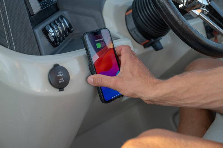 ICM_MAX_MAGNETIC_WIRELESS_CHARGER_APPLICATION_PONTOON_HELM_INSTALL_MALE_PLACING_PHONE_ON_CHARGER_CLOSEUP_2-1200x800-5b2df79.jpg