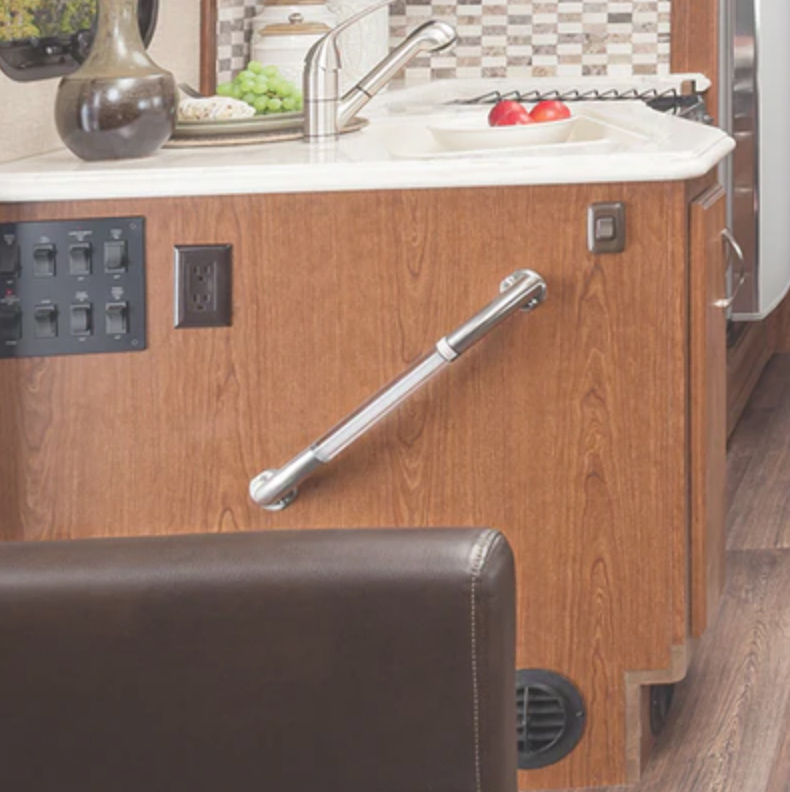 Cropped image of stair assist handle mounted to RV kitchen cabinetry